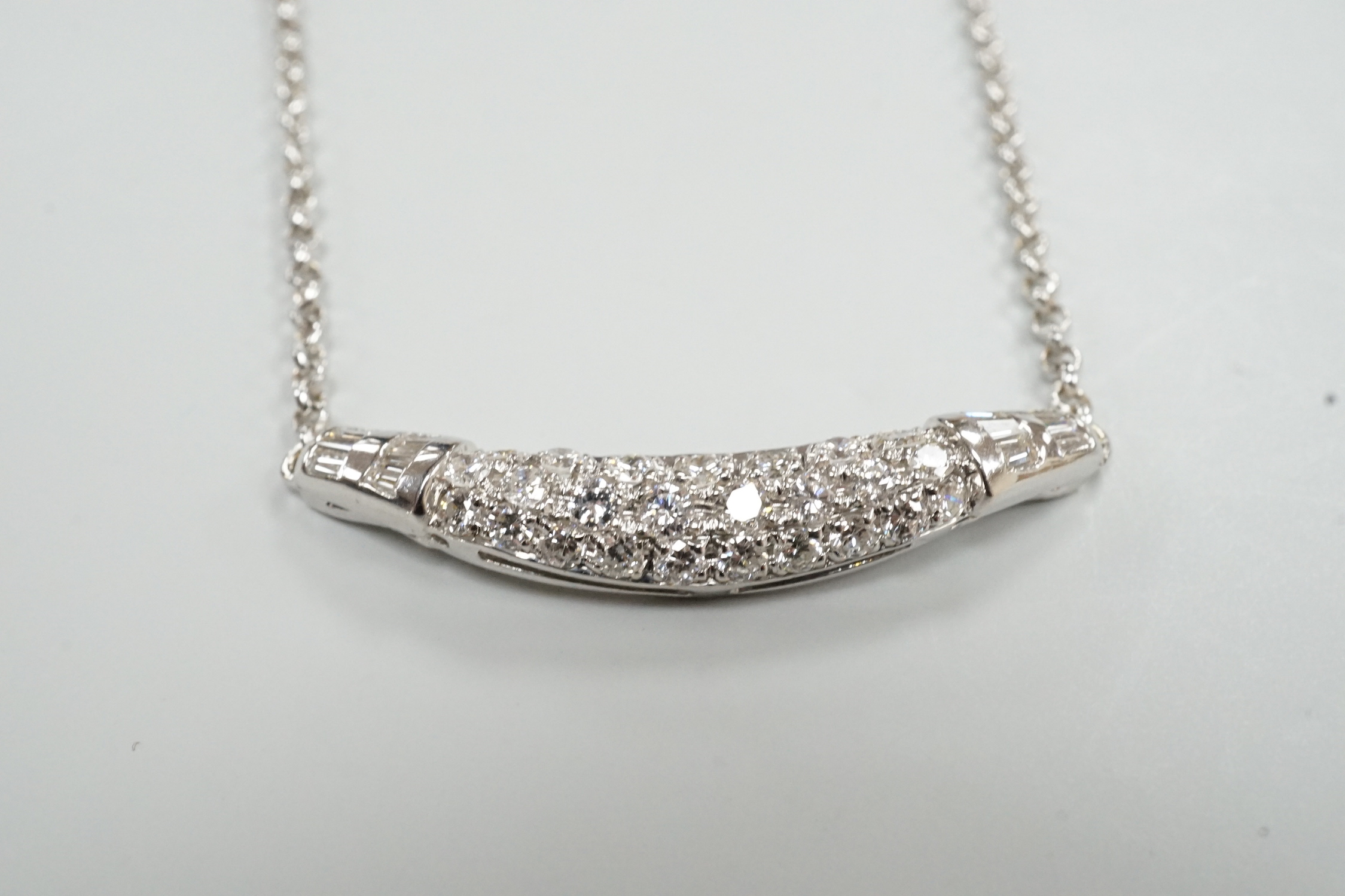 A modern Italian 750 white metal, trapeze and round cut diamond set cluster pendant necklace, 44cm, gross weight 8.8 grams.